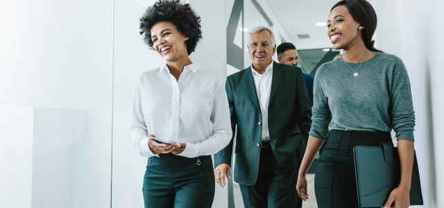 Team of corporate professionals in office corridor
